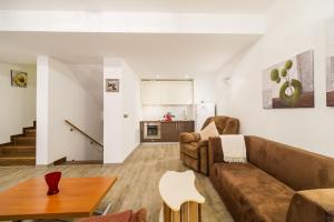uma sala de estar com um sofá e uma mesa em Loft Apartment Silver Mountain em Poiana Brasov