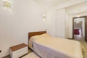 a bedroom with a bed and a dresser in it at Loft Apartment Silver Mountain in Poiana Brasov +32 photos