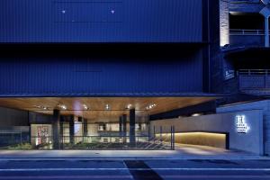 an external view of a building at night at Piece Hostel Sanjo in Kyoto