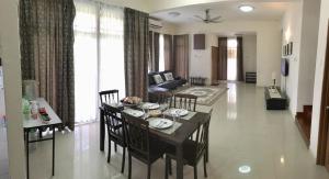 a dining room and living room with a table and chairs at Putrajaya 1808 Homestay in Putrajaya