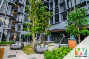a group of trees inront of a building at Expressionz Suites, 300mbps Wifi, near KLCC, IJN by Wodages in Kuala Lumpur