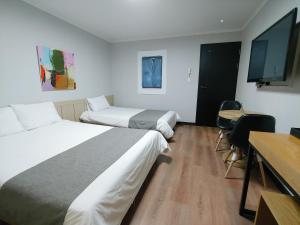 Postel nebo postele na pokoji v ubytování Hotel Tong Yeondong Jeju
