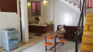 a living room with a table and a kitchen at Be Relaxing @ NO. 1 Galle City in Galle