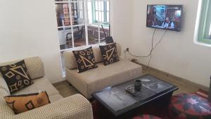 a living room with two chairs and a tv at Be Relaxing @ NO. 1 Galle City in Galle