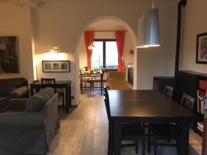 a living room with a table and a dining room at Baita Sorriso in Brunate