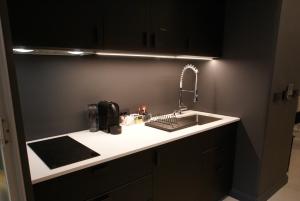 a kitchen counter with a sink and a microwave at Fingerprint Tree Apartments - Delux in Zagreb