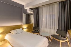 um quarto de hotel com uma cama e uma mesa em Hotel Silva em Timişoara mais 37 fotografias