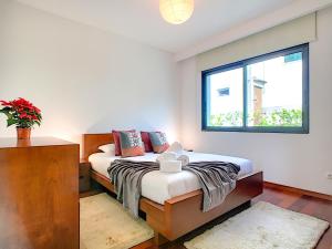 a bedroom with a bed and a window at Villa North Sea by LovelyStay in Ponta Delgada +16 photos