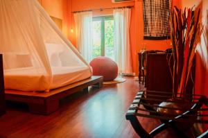 a bedroom with a bed and a vase on the floor at iRoHa Garden Hotel & Resort in Phnom Penh