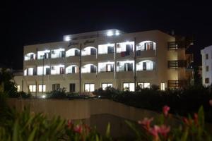 a building with lights on top of it at night at Bikini Hotel in Vieste