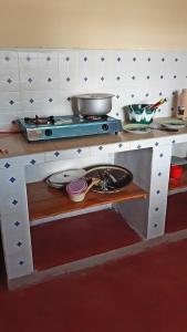 a model of a kitchen with a counter with a stove at Mgeni Homestay in Kilindoni