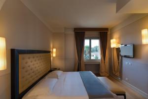 Posteľ alebo postele v izbe v ubytovaní Hotel Palazzo San Lorenzo & Spa