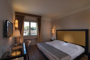 Posteľ alebo postele v izbe v ubytovaní Hotel Palazzo San Lorenzo & Spa
