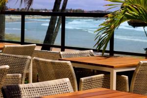 a table and chairs with a view of the ocean at Namoa Pousada in Cabo de Santo Agostinho +80 photos