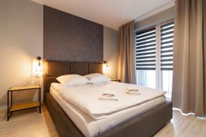 Posteľ alebo postele v izbe v ubytovaní Apartamenty Białystok - Botaniczna 9A/21