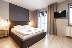 Posteľ alebo postele v izbe v ubytovaní Apartamenty Białystok - Botaniczna 9A/21
