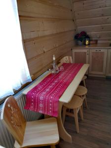 a table in a cabin with a table cloth on it at Pokoje goscinne u Jozka in Chochołów