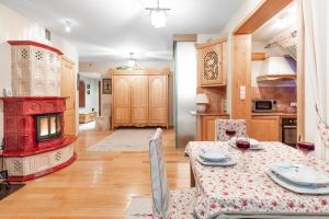 comedor con mesa y estufa roja en Apartament Bajeczna Góra Zakopane, en Zakopane