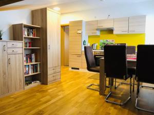 a kitchen with a table and chairs in a room at Ferienwohnungen Bachblick in Übersee