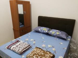 A bed or beds in a room at Address No 915, Lorong Uni Central 13, Taman Uni Central, Kuching Samarahan Expressway