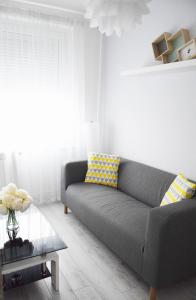 a living room with a couch and a table at White Almond Apartment in Budapest