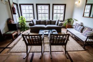 a living room with a couch and two chairs and a table at Apartamentos Los Telares in Hermigua