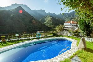 a swimming pool with a view of mountains at Apartamentos Los Telares in Hermigua