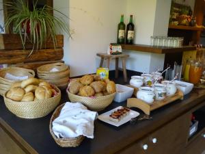 a counter with baskets of bread and other foods on it at Hotel Sporthof in Schladming