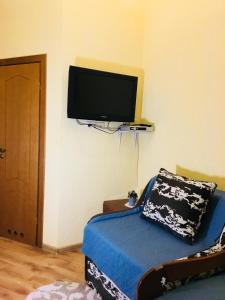 a bedroom with a bed and a tv on the wall at Апартаменти готельного типу in Lviv +33 photos