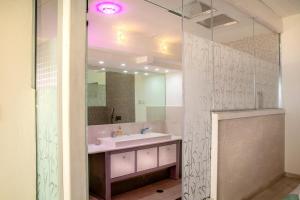 a bathroom with a sink and a mirror at Michelle Suite סוויטת מישל in Amirim +14 photos