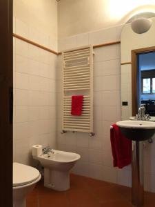 a bathroom with a toilet and a sink at Casa vacanze Filippo in San Siro +20 photos