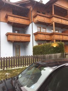 a car parked in front of a building with wooden balconies at House Arianna in Bad Kleinkirchheim