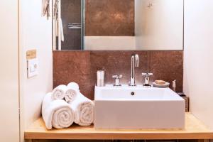 a bathroom with a sink and towels on a counter at BC MAISON bed&cafe Milano in Milan