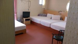 Letto o letti in una camera di Kai Cheng Inn 旅館134