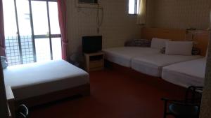 Letto o letti in una camera di Kai Cheng Inn 旅館134