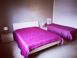 Posteľ alebo postele v izbe v ubytovaní FIORI E COLORI