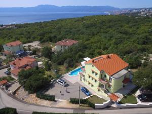 an aerial view of a house and a swimming pool at Luxury apartments Kostrena with pool 2 in Kostrena