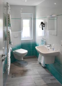 a bathroom with a toilet and a sink at Ferienhaus Wittig in Löbnitz