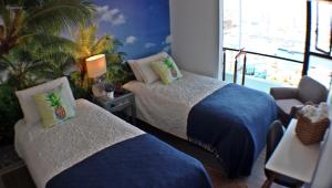 a hotel room with two beds and a window at Departamento de lujo Antofagasta in Antofagasta +37 photos