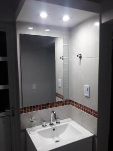 baño con lavabo y espejo grande en Alquiler Céntrico Catamarca en San Fernando del Valle de Catamarca