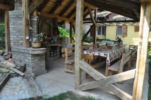 a patio with a table and chairs in a house at Apartments Borove Noci in Vrdnik