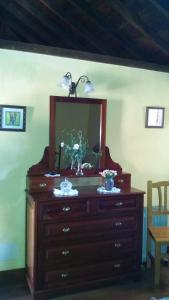 a dresser with a mirror on top of it at Casas Rurales Los Marantes in Puntagorda