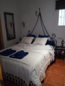 ベヘール・デ・ラ・フロンテーラにあるLa Suite del Alfizの白い大型ベッド(青い枕付)