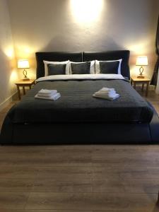 a bedroom with a large bed with two lamps at Casa Oliver in Braşov +22 photos