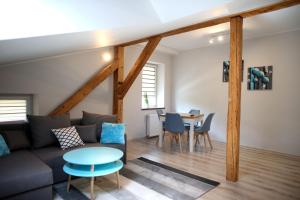 a living room with a couch and a table at Apartamenty "Kotlina" in Bystrzyca Kłodzka