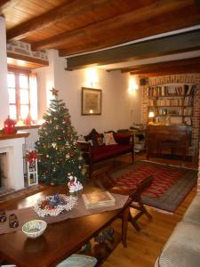 a living room with a christmas tree in a living room at Xenonas ton Chromaton in Lafkos +88 photos