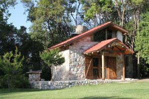 a small stone building with a sign on it at La Casa de Wanda in Villa de Las Rosas
