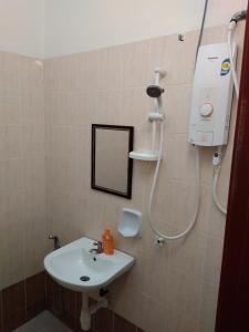 a bathroom with a sink and a shower at ARUWDA Homestay in Ipoh