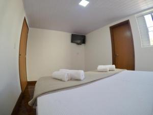 Кровать или кровати в номере Pousada Bougainville