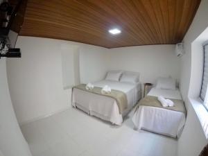 Uma cama ou camas num quarto em Pousada Bougainville